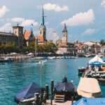 a body of water with boats and buildings in the background