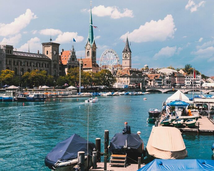 a body of water with boats and buildings in the background