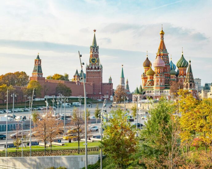 View of St. Basil's Cathedral and Kremlin during a sunny day in Moscow, Russia. Iconic tourist attraction.