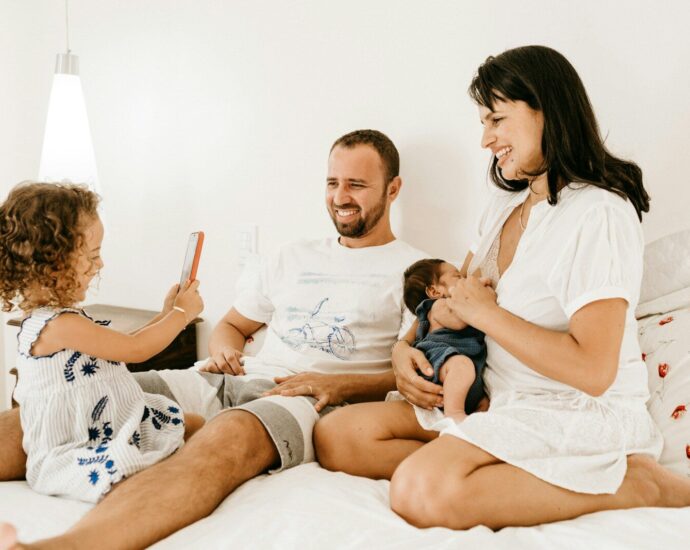 man in white crew neck t-shirt sitting beside woman in white crew neck t-shirt