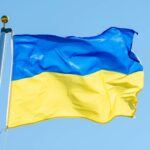 a blue and yellow flag flying in the wind