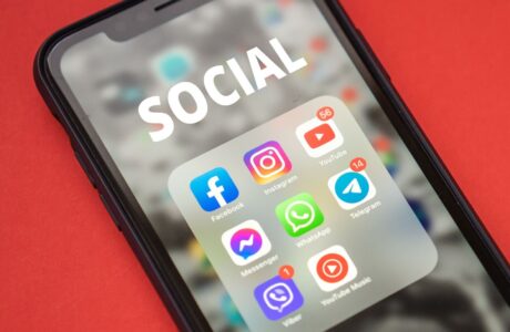 Close-up of a smartphone showing popular social media apps on screen.