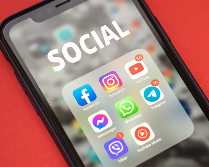 Close-up of a smartphone showing popular social media apps on screen.