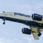 a jetblue airplane is flying in the sky