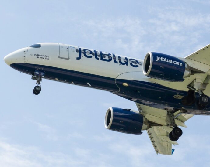 a jetblue airplane is flying in the sky
