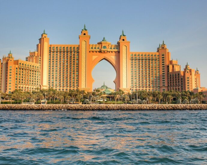 a very tall building sitting on top of a body of water