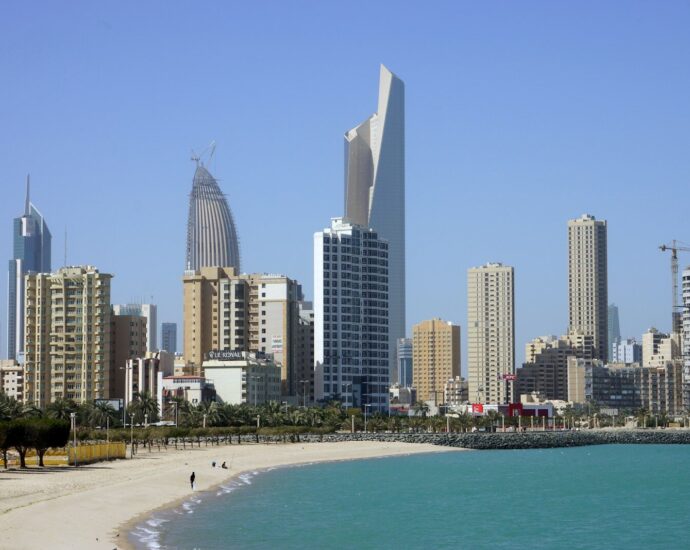 people on beach near high rise buildings during daytime