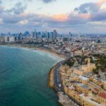 aerial view of city buildings near sea during daytime