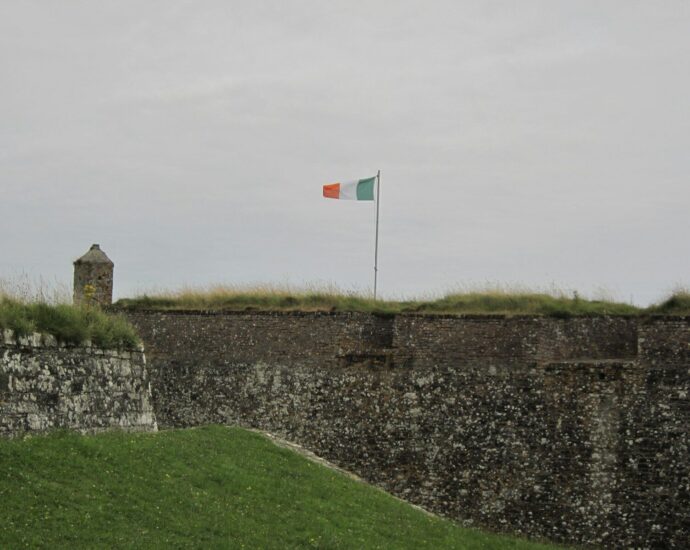 a flag on top of a stone wall
