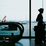 Silhouette of a woman with suitcase at airport