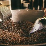black and white ceramic fish figurine on black and brown coffee beans