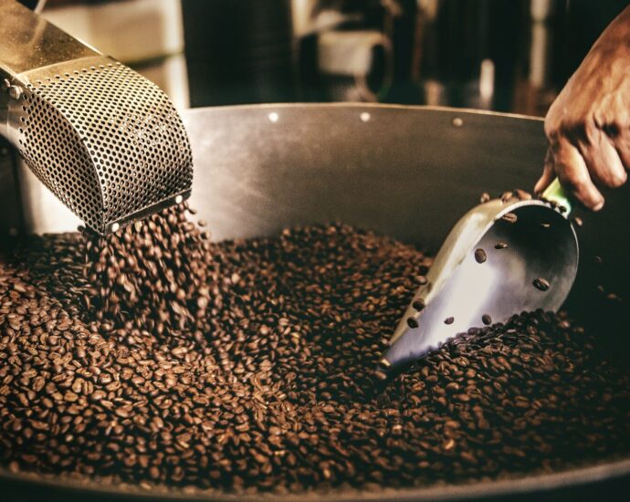 black and white ceramic fish figurine on black and brown coffee beans