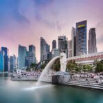 Stunning view of Singapore's skyline featuring the famous Merlion fountain at dusk.