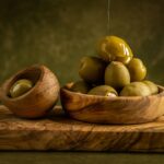 a wooden spoon with a group of potatoes on it