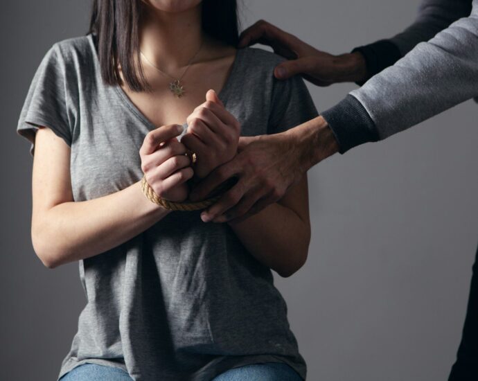woman in gray scoop neck shirt holding her hands