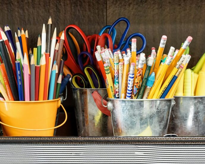 assorted color pencils in yellow bucket