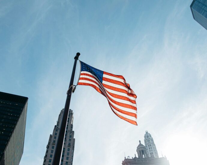 USA flag on pole at the city during day