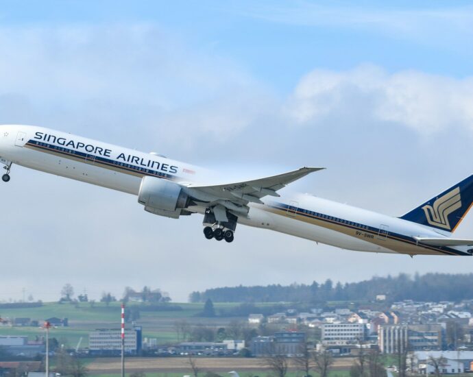 A large jetliner flying through a blue sky