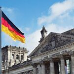 The German flag flying above the Reichstag building in Berlin, Germany.