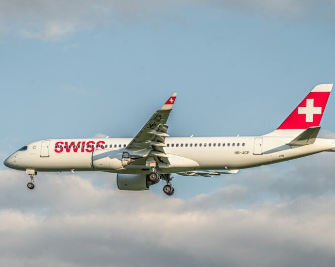 a large passenger jet flying through a cloudy sky