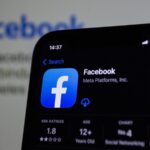 a close up of a cell phone with facebook on the screen