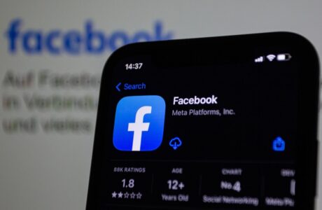 a close up of a cell phone with facebook on the screen