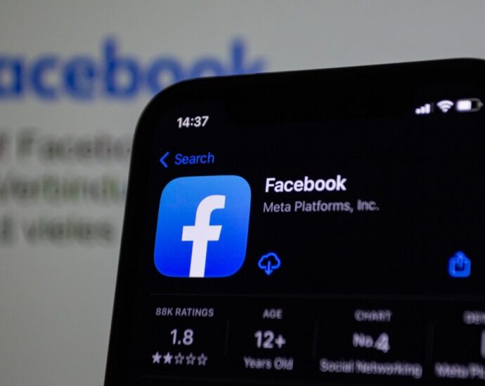 a close up of a cell phone with facebook on the screen