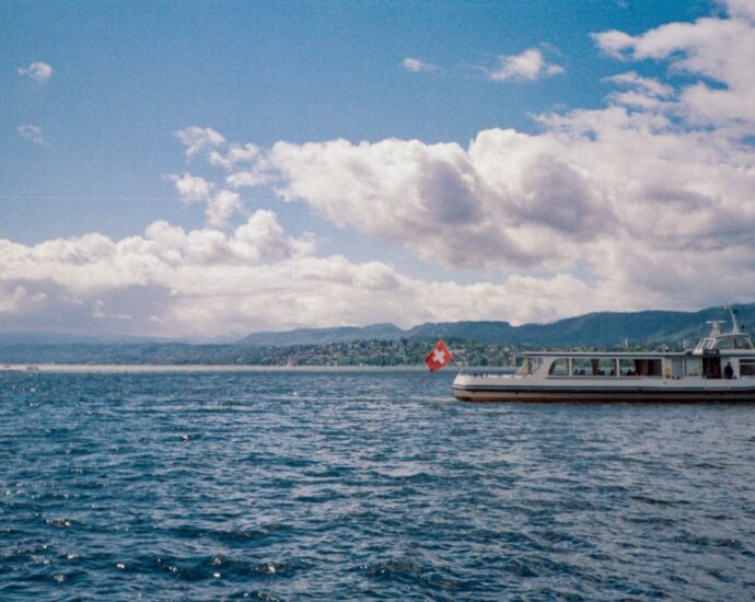 Boat sailing on a lake with mountains in the background
