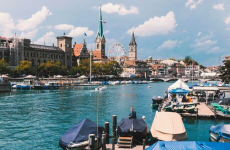 a body of water with boats and buildings in the background