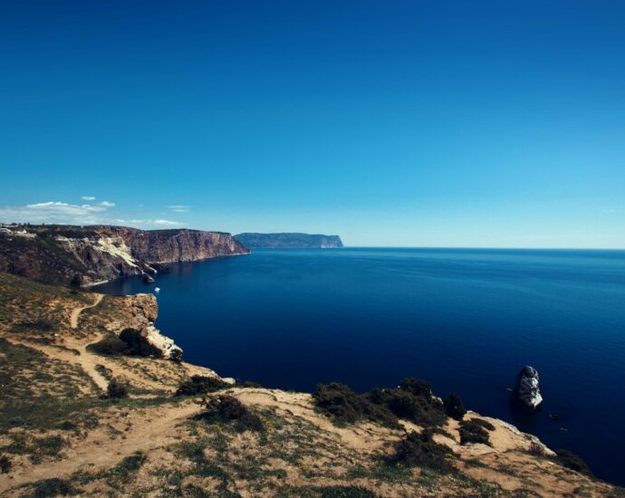 body of water surrounded by rock