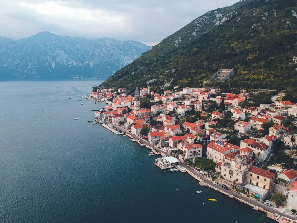 an aerial view of a small town on the shore of a lake