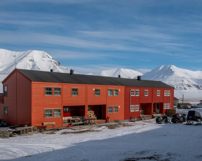 Orange buildings in a snowy arctic landscape