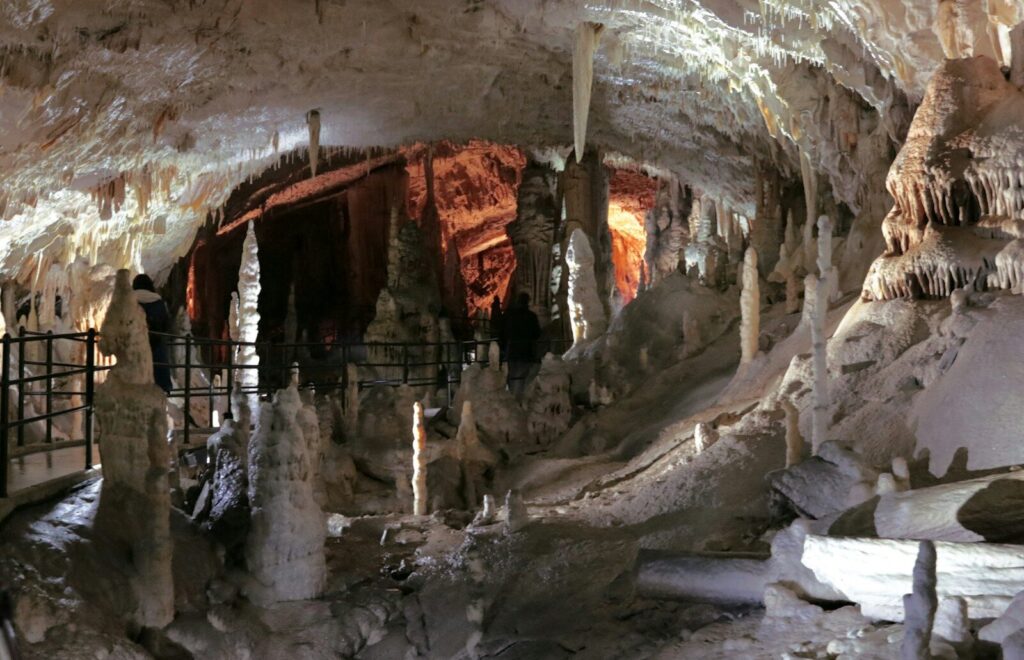 a group of people standing inside of a cave