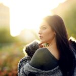 selective focus photography of standing woman wearing gray fur jacket