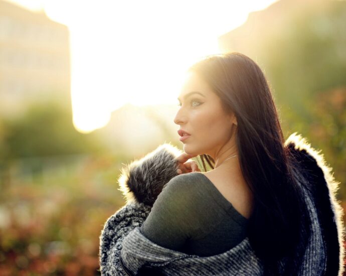 selective focus photography of standing woman wearing gray fur jacket