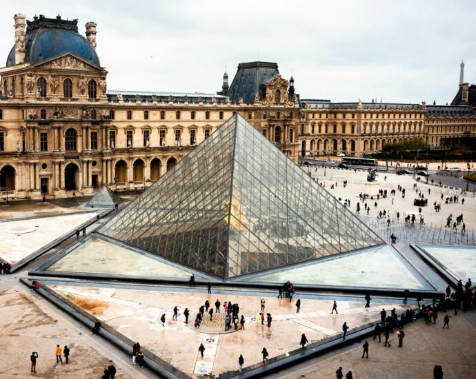 a large glass pyramid in front of a building