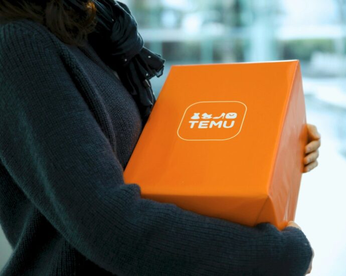Woman holding an orange temu package